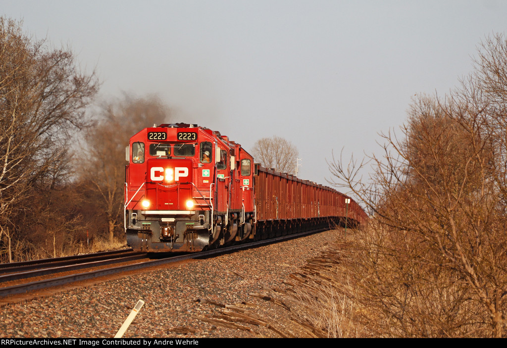 WWA job crests the hill approaching O'Connor Rd. with a trio of EMDs and a string of Herzog loads